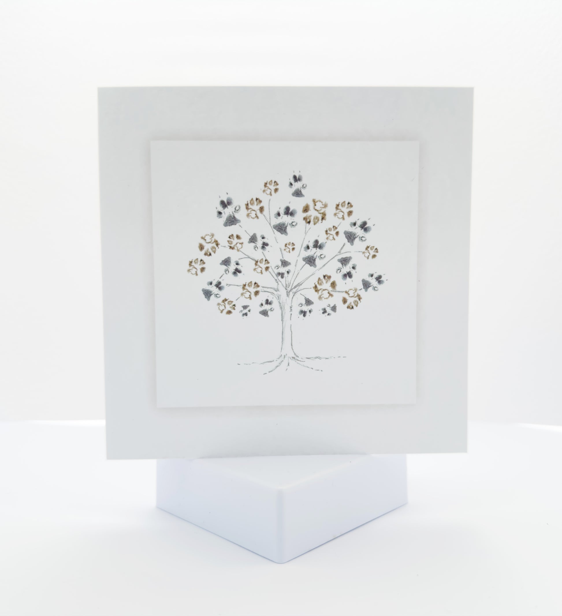 Pencil sketch of a tree with pet paw prints as leaves