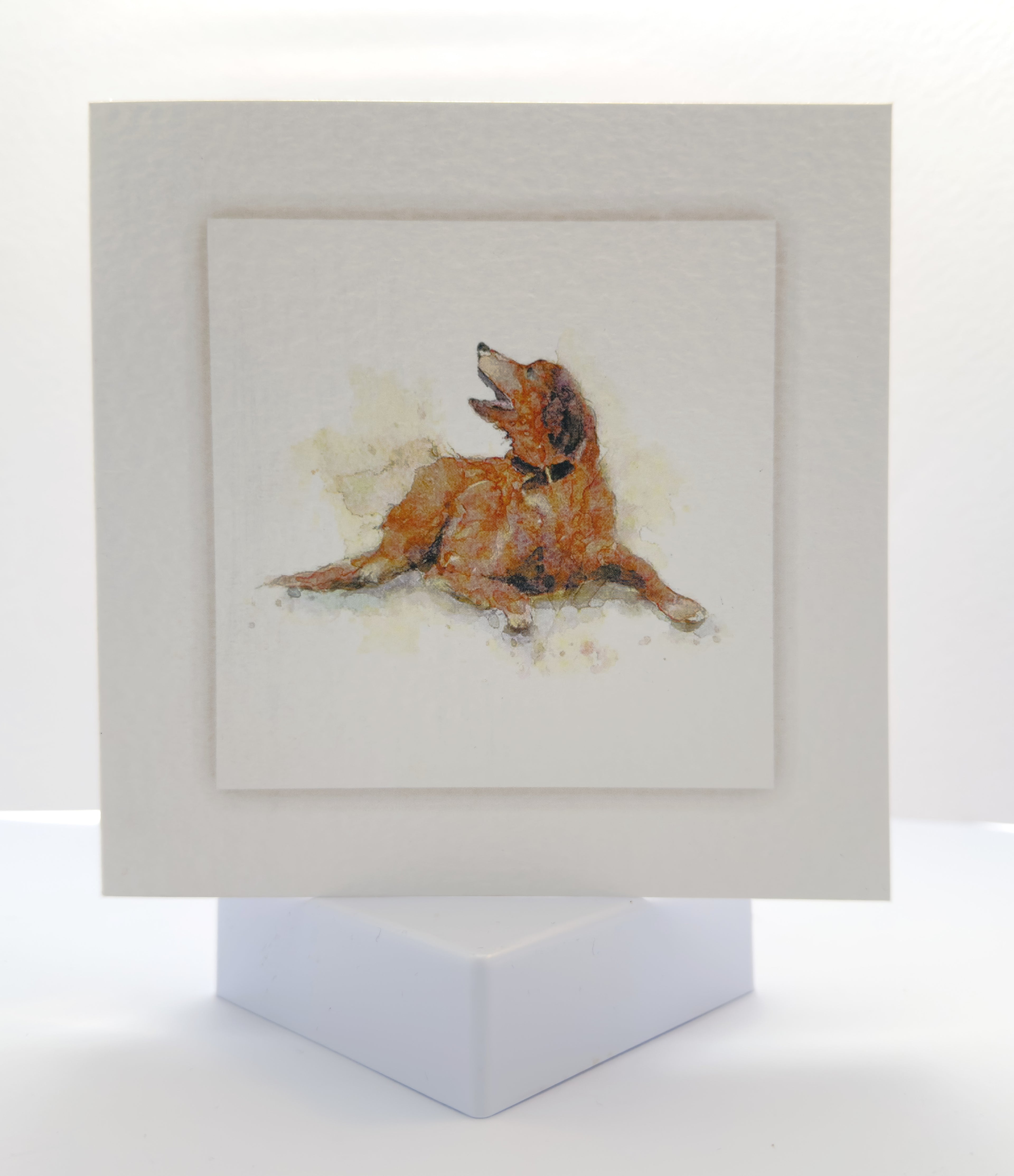 watercolour painting of a brown dog lying down with head up