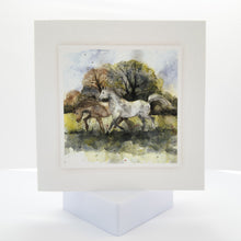 watercolour painting of two horses galloping in a field